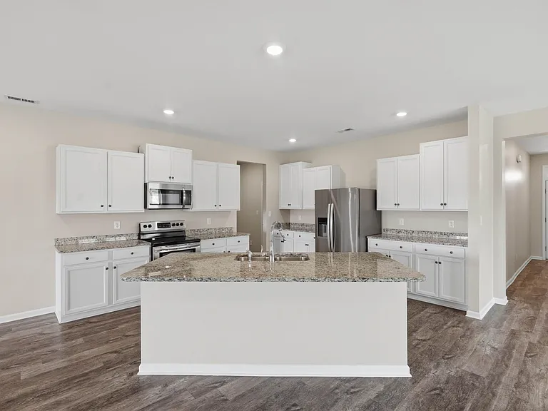 Granite countertops, open to living and dining areas