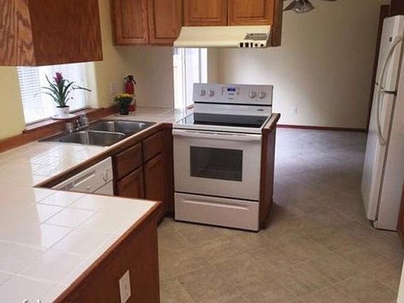 Newer range and dishwasher in the kitchen. Kitchen opens int