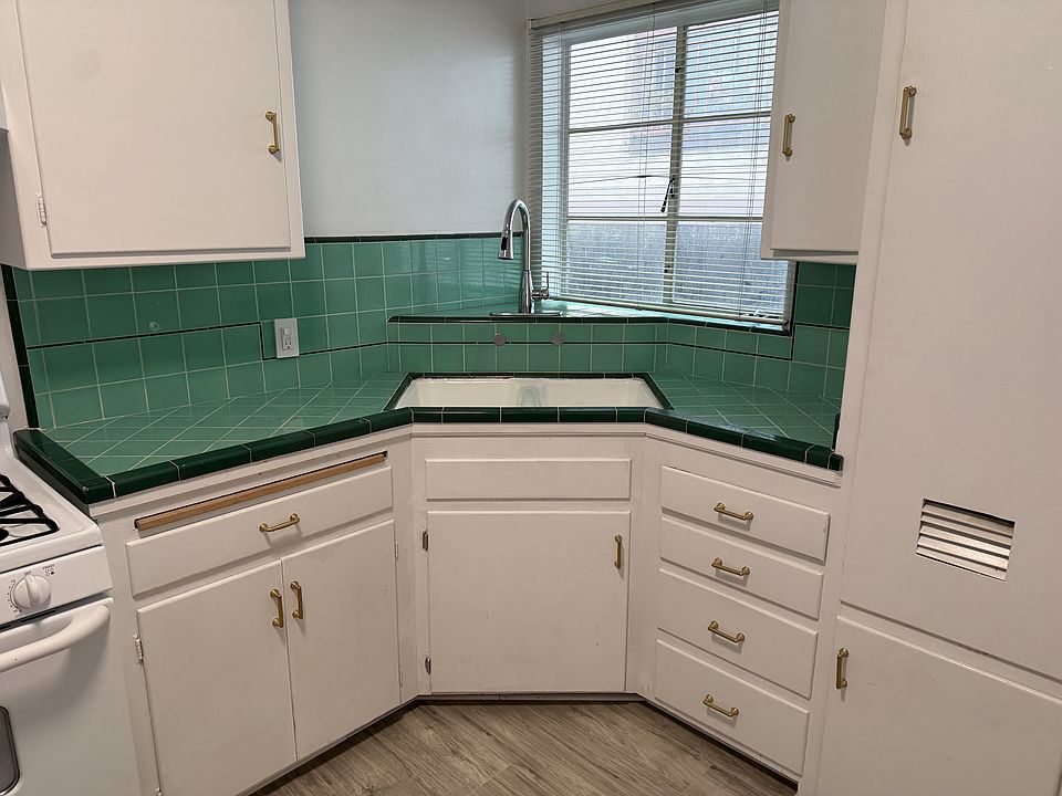 Large kitchen faucet with hose and sprayer! Large sink. Window over kitchen sink.
