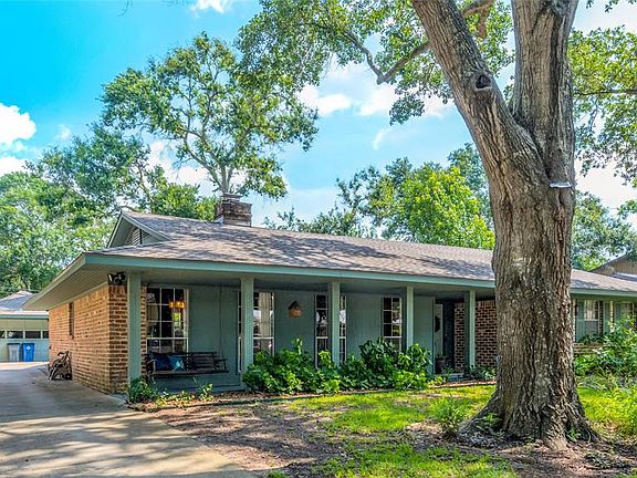 The front of the home has mature trees and Native Texas Landscaping that is low maintenance and not watering requirements; Driveway gives access to the detached double garage; recent roof (2020)