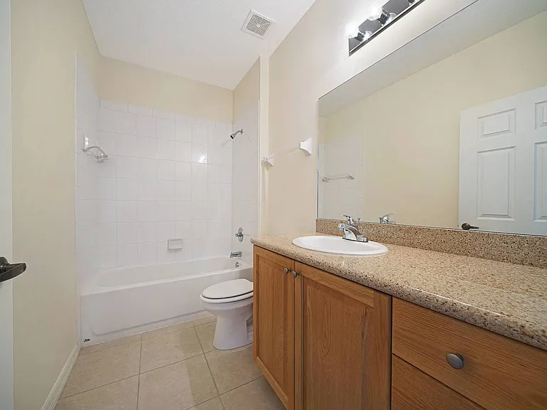 Guest bathroom w/ bath/shower combo and granite counter top