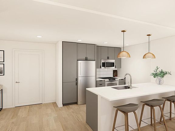 Sleek kitchens at Modera Bridle Trails feature spacious islands, designer finishes, and open layouts.