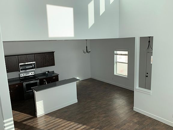 View of kitchen and dining room from stairs.