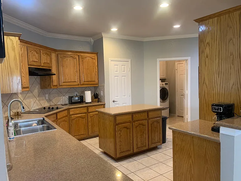 Kitchen is spacious with adjoining laundry room: HE washer and front loading dryer.