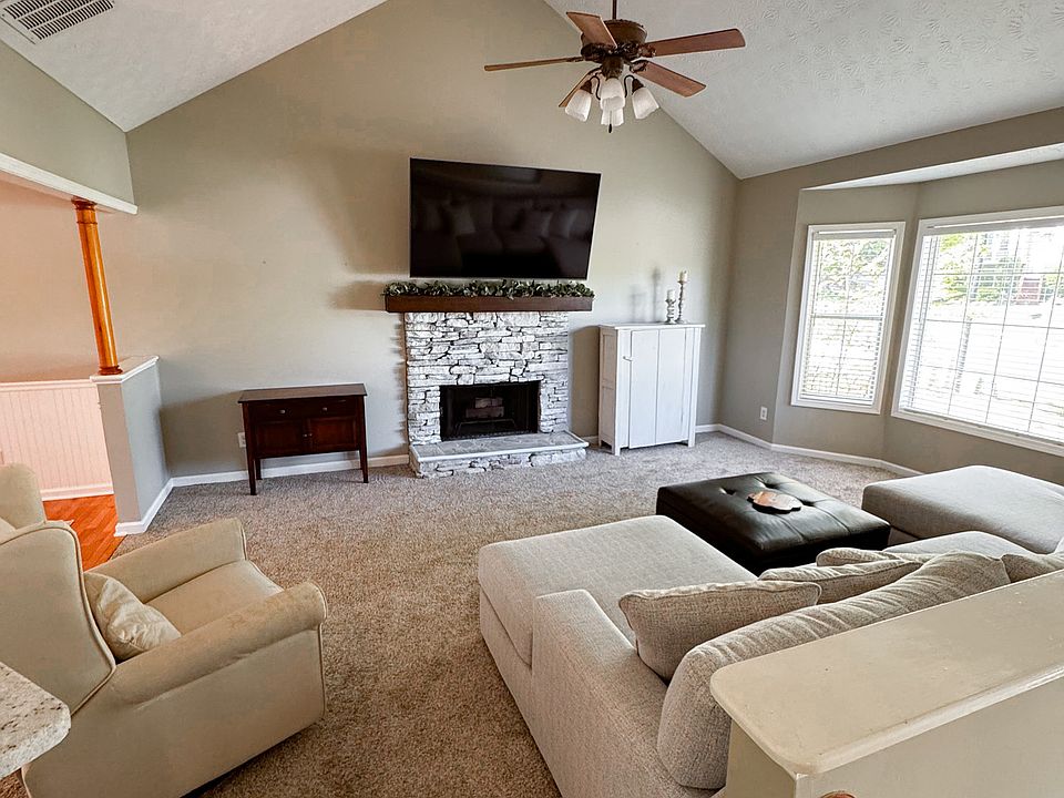Step inside to a spacious living room with soaring 18-foot ceilings and a bright bay window that fills the space with natural light_perfect for relaxing or entertaining.