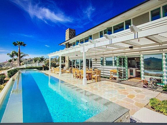 Stunning lap pool/yard with endless views overlooking polo fields and all the way to the ocean