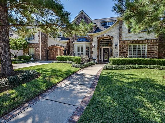 Gated 3 car attached/detached car court with wrought iron gate. Incredible outdoor living area with fireplace, summer kitchen, private backyard (no neighbors behind).