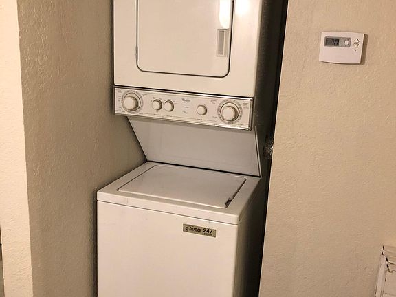 Stackable washer and dryer in hall