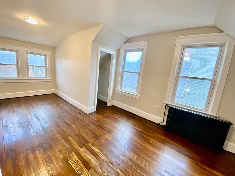 (second floor)left side large bedroom, 2 full closets, 4 full windows, LED lighting, hardwood floors with wide base moldings.