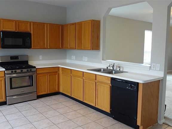 Newer appliances add to the kitchen's functionality. Look at all that work space!