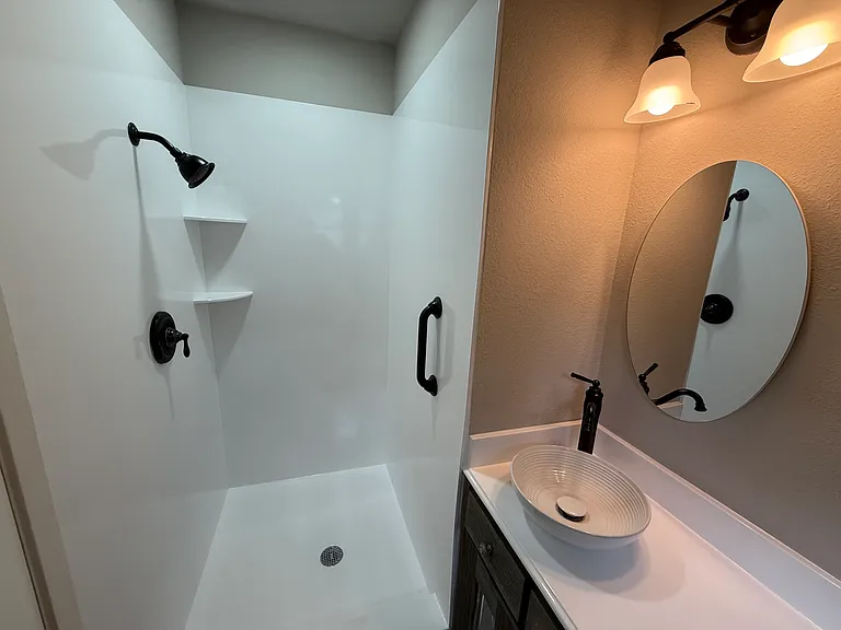 The Master Bath has a spacious walk-in shower with contemporary fittings.
