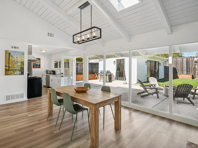 Wall of windows overlooking the private backyard and detached guest studio