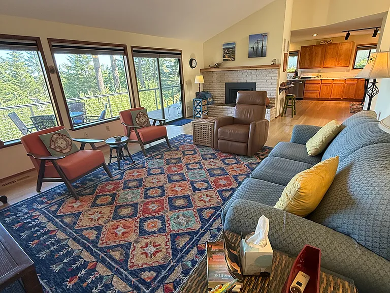 Front room with tree top view windows