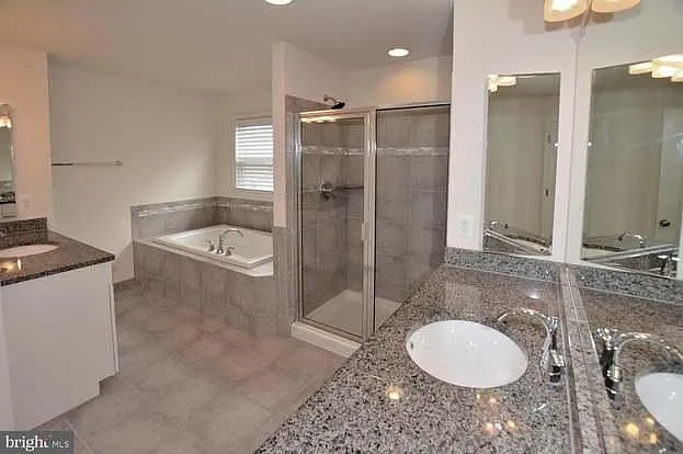 Primary bathroom private toilet, Tub, Standing shower, Double sinks.