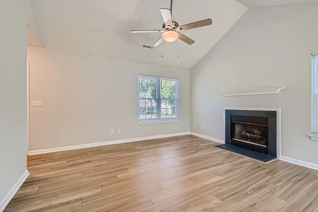 Luxury vinyl plank flooring throughout. Vaulted ceiling, gas fireplace. - 266 Indian Paint Brush Dr