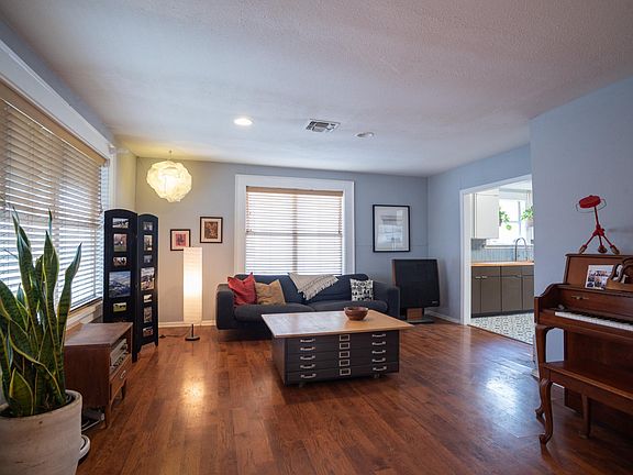 Spaceous living area with large picture windows.
