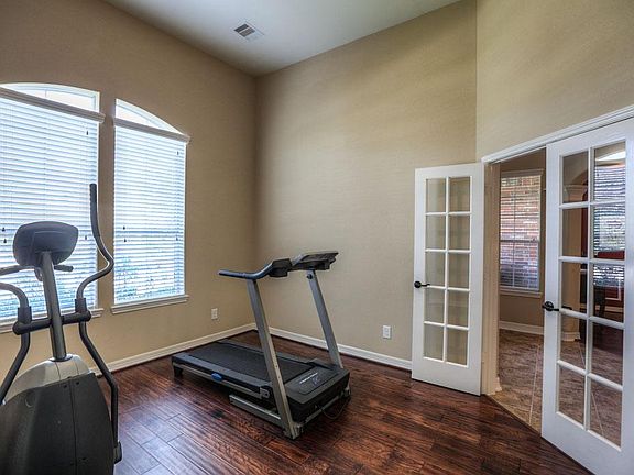 To the Right in the Entryway, These Glass French Doors Lead To a Study with Laminate Wood Floor and 