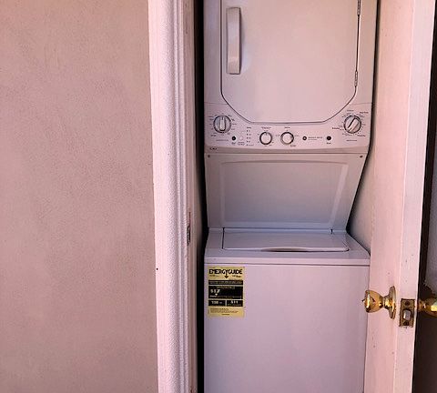 laundry between bathroom & bedroom walls opening outside