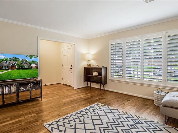 The bright formal living room welcomes you into the home. Site-finished solid oak wood floors (species: red oak; stain: nutmeg; finish: matte) in all non-wet areas plus the kitchen.