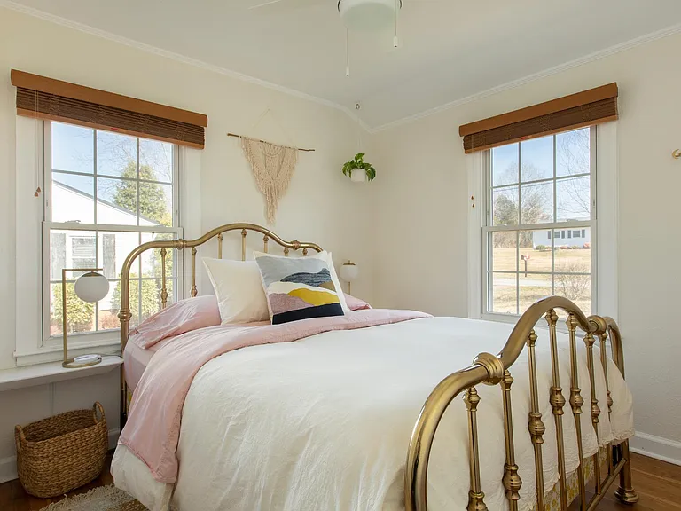 Small second bedroom with two windows - both have custom shades.