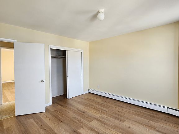 Living room with lots of natural light and a full closet for storage. New wood flooring.