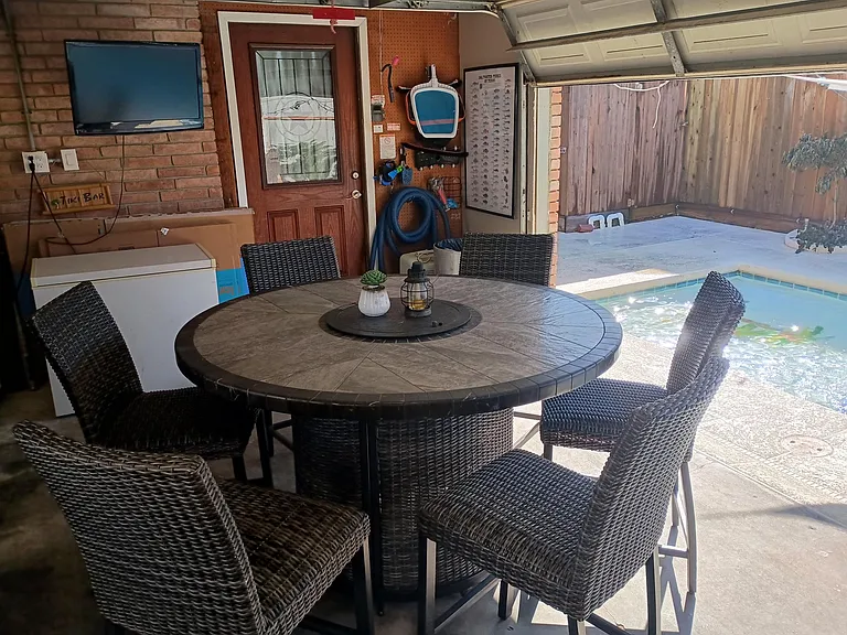 Relax & socialize pool side. (Garage)