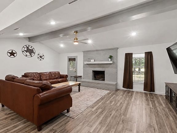 Luxury Vinyl Plank flooring and wood burning fire place.
