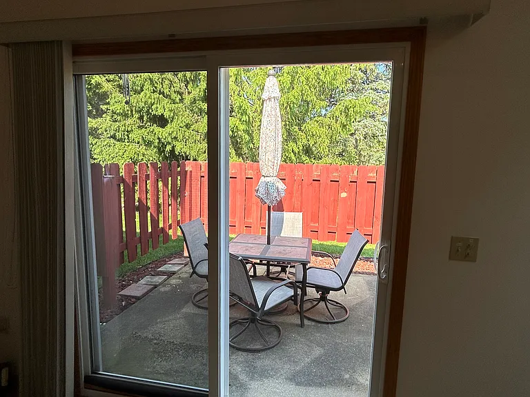 Glass sliding door to private patio, furniture stays if desired.
