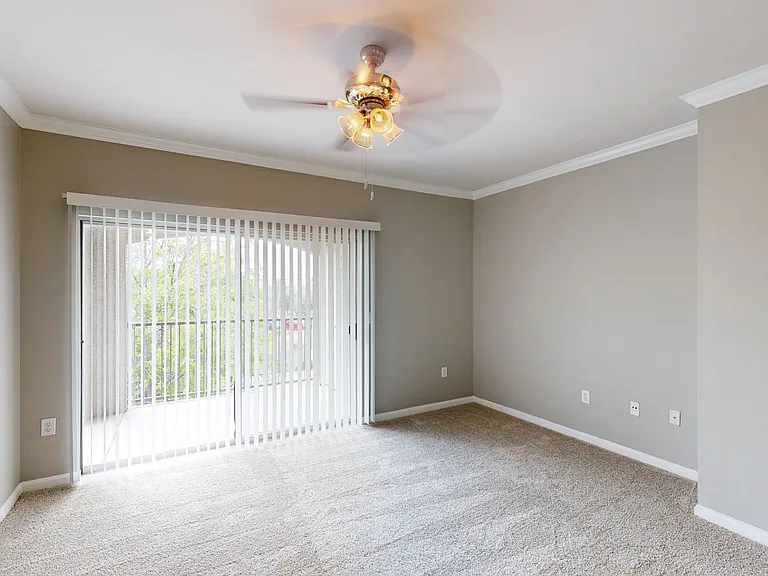 Apartment living room with plush carpet flooring.