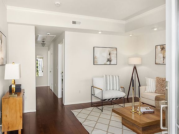 Hallway leads to bathroom, office and two bedrooms. Pull down attic stairs at end of hallway.
