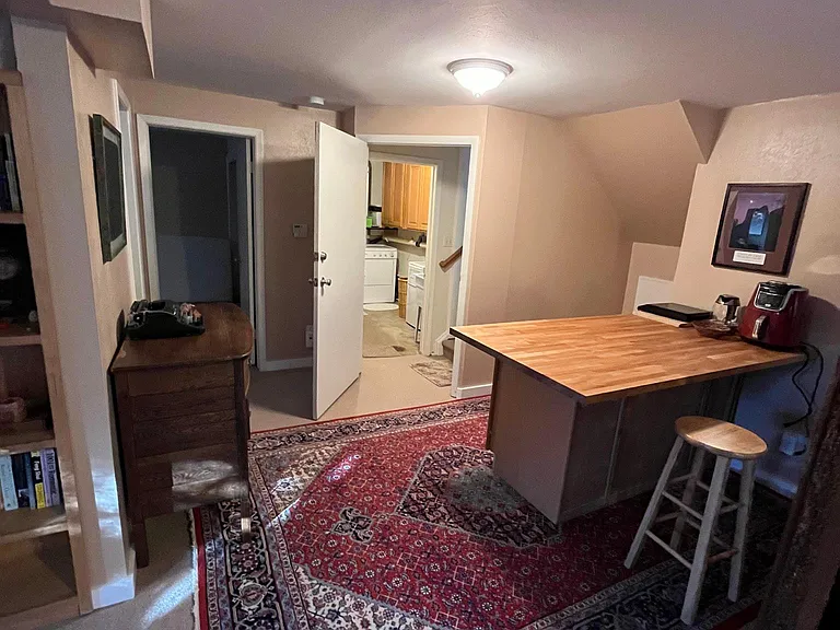 The medium fridge isn't shown in this picture, but is behind the door that leads into the basement.