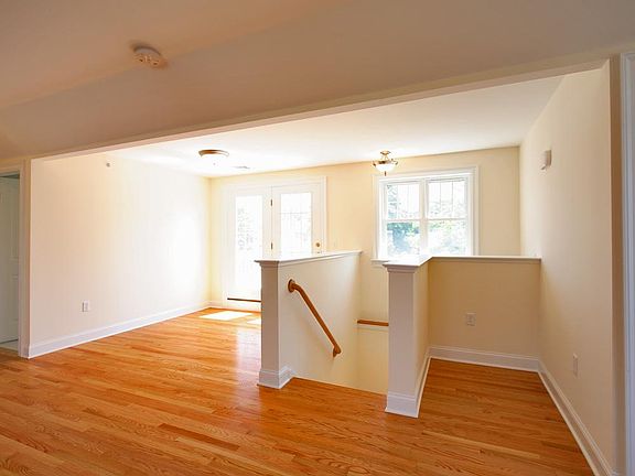 Stairway, small desk area, and patio doors out to deck area