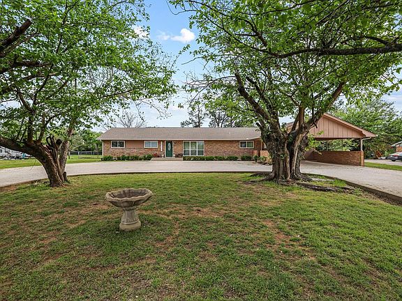 All brick ranch home with large circle drive and mature trees