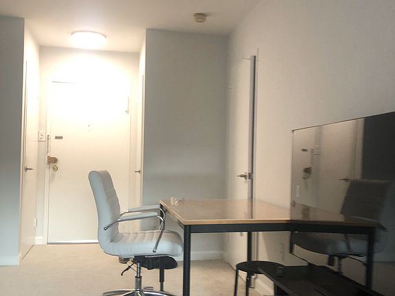 Workstation/desk and 55"TV on storage stand.