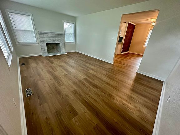 living room with white washed brick fireplace (plumbed for gas logs)