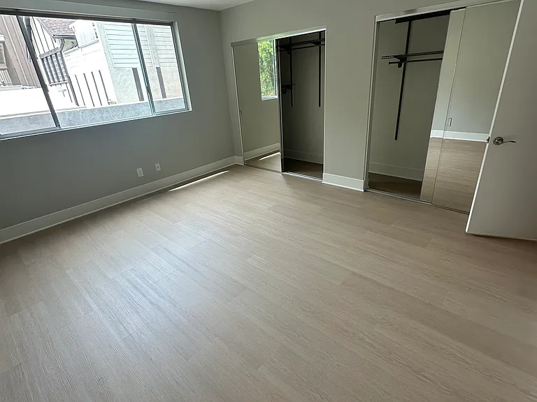 Bedroom with a wall of connecting closets