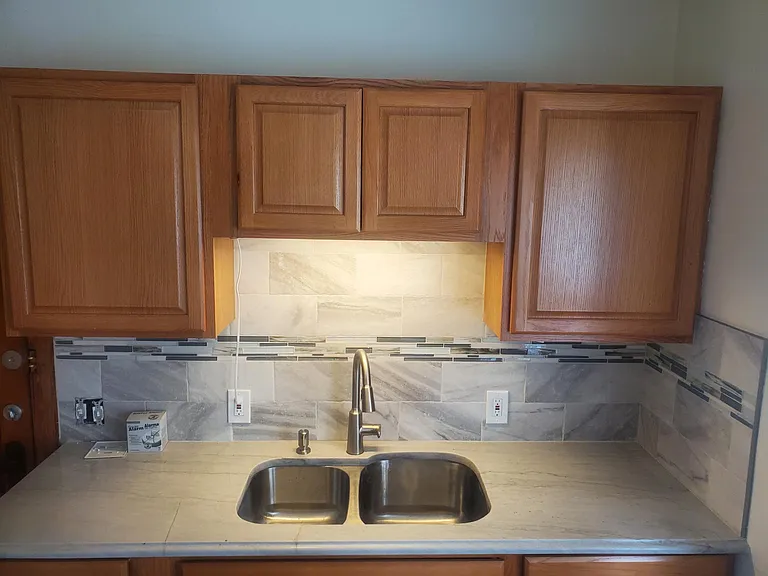 New granite counter top and ceramic tile back splash