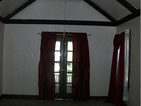 Living room Cathedral ceiling ,french doors leading to balco