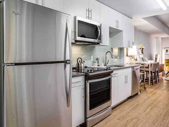 Studio Kitchen with Stainless Steel Appliances and Quartz Countertops. Furnishings by Room & Board