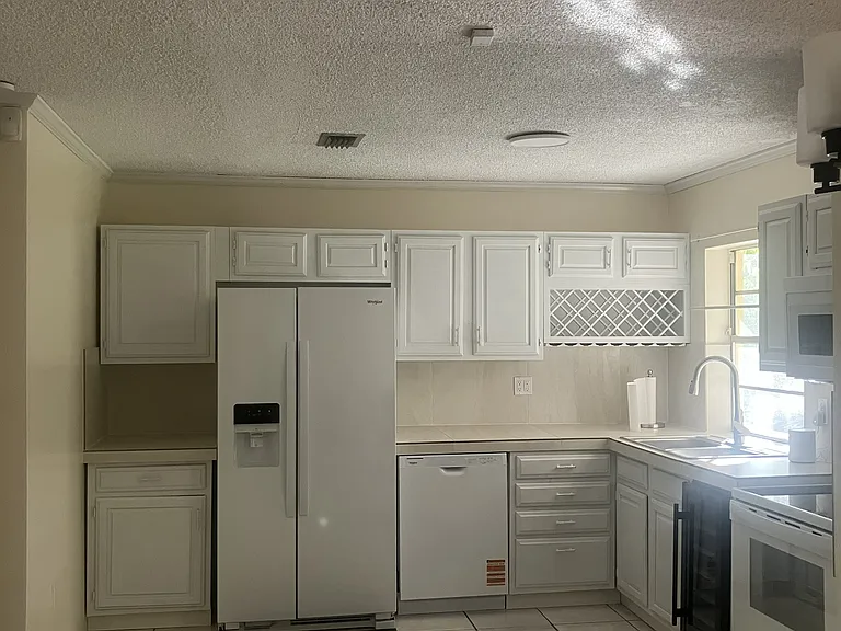 New kitchen appliances-refrigerator, dishwasher, range, microwave, and 30 bottle wine cooler.