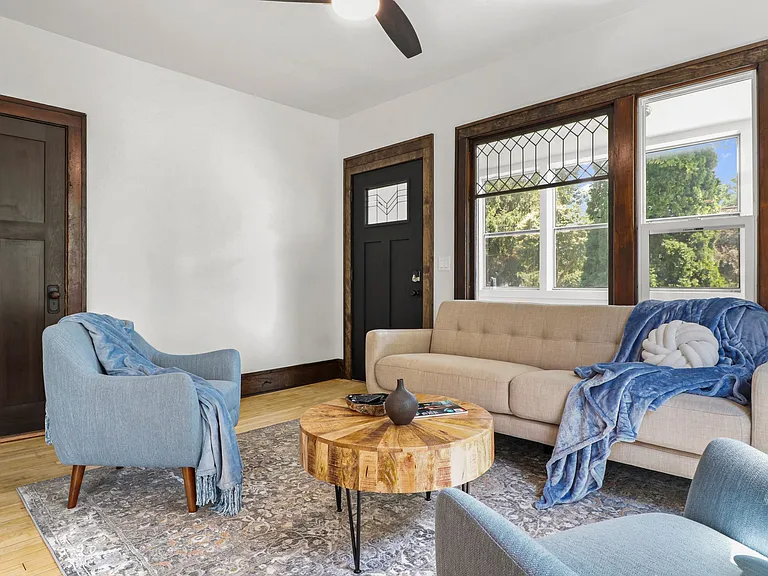 Look outside into this sweet neighborhood, close to everything. How pretty those door and windows are! There is a large front porch that is covered giving you extra space and a buffer from outside to inside.