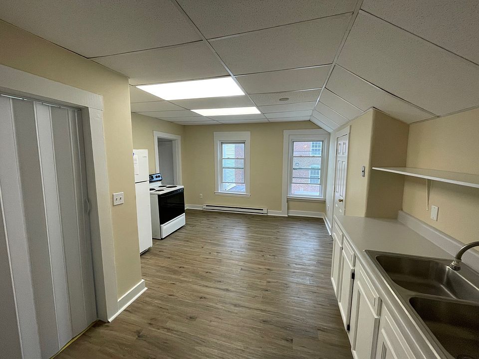 Large kitchen area with natural light and pantry closet.