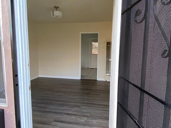 From the porch, a view into the living from, kitchen, and a second entry to the backyard.