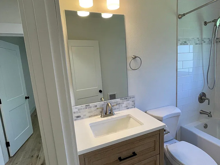 Hall Bathroom vanity with marble backsplash