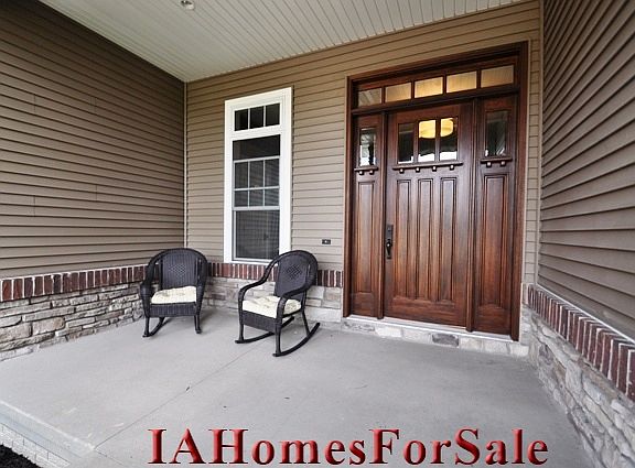 Entry with large covered stoop and 8 ft mahogony door.