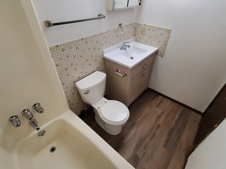 Clean, Bright, Bathroom, with Brand New Vanity, Sink, Faucet, and Luxury Vinyl Plank Flooring