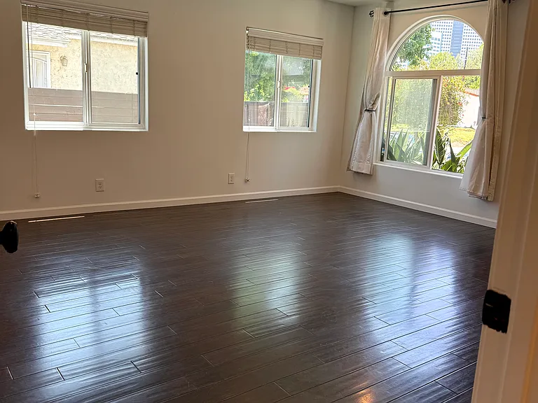 Bright living room filled with natural light and dimmable recessed LED lighting.