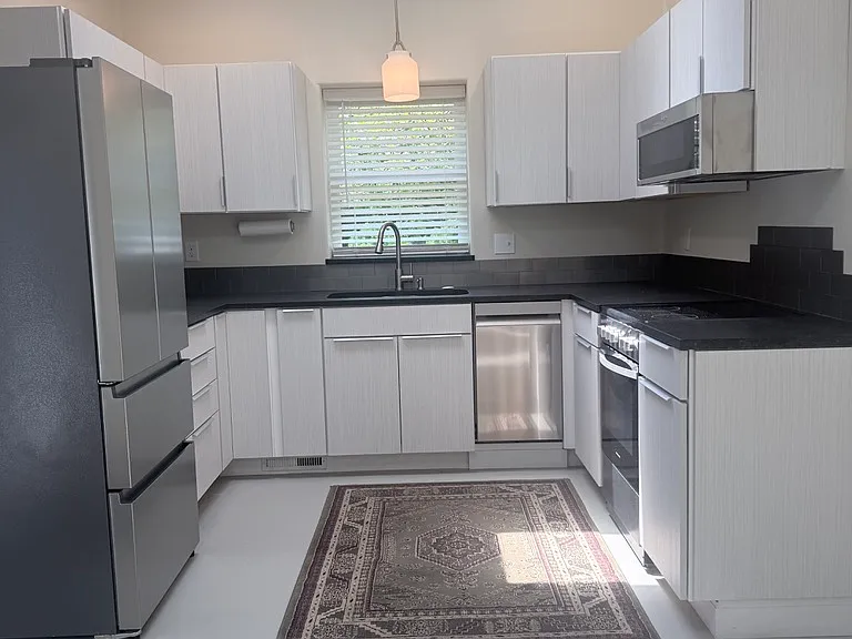 Closer view of kitchen with lights on.