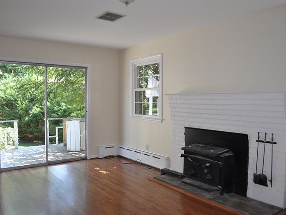 Family room with woodstove and sliders to deck.