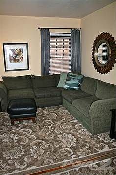 Living Room of this adorable cottage.  There are gorgeous hardwood floors under these area rugs